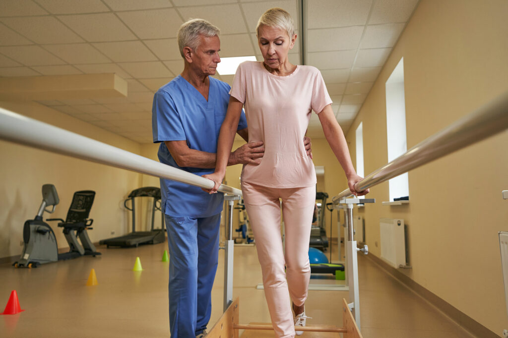 Stroke patient in rehab with physical therapist.